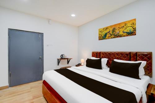 a bedroom with a large bed in a room at Super Townhouse Vanasthalipuram Near Deer National Park in Hyderabad