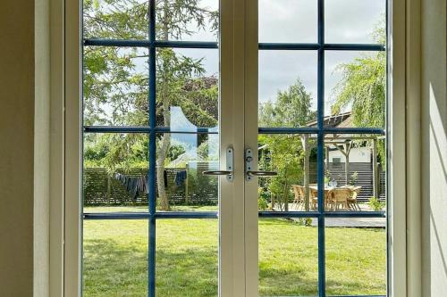 an open door with a view of a yard at Spacious House With Sea Views In Österlen in Borrby