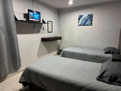 Una cama o camas en una habitación de El Hostalito Metepec