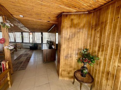 a hallway with a wooden wall with a vase on a table at Leo's Cappadocia in Goreme