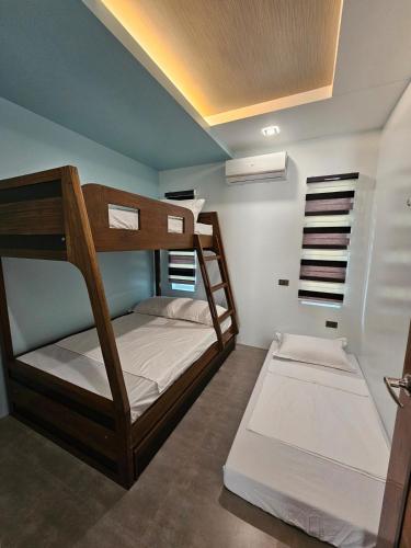 a bunk bed room with two bunk beds in it at Bulihan Suites Puerto Galera in Puerto Galera