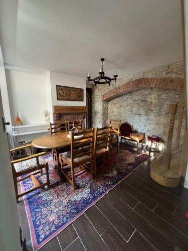 a dining room with a table and chairs and a fireplace at Seven Sisters, Glastonbury in Glastonbury
