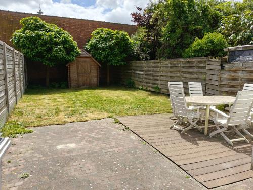 a patio with a table and chairs in a yard at House with garden in Turnhout