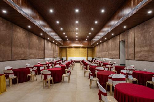 a large room with red tables and chairs at Premier Greens in Mūlki