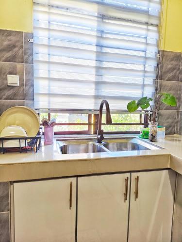 a kitchen with a sink and a window at Narasya Homestay Wakaf Tengah Batu Rakit in Kuala Terengganu