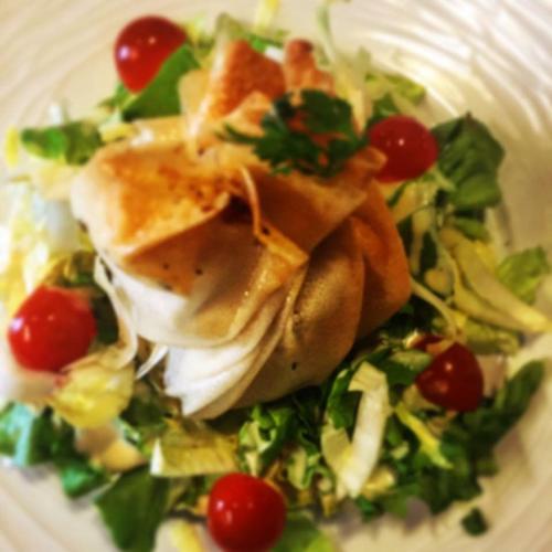 a white plate of food with lettuce and tomatoes at Logis Hotel La Grange Du Relais in Colombey-les-deux-Églises