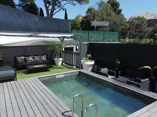 une cour arrière avec une piscine et une clôture noire dans l'établissement Appartement Montpellier, à Montpellier