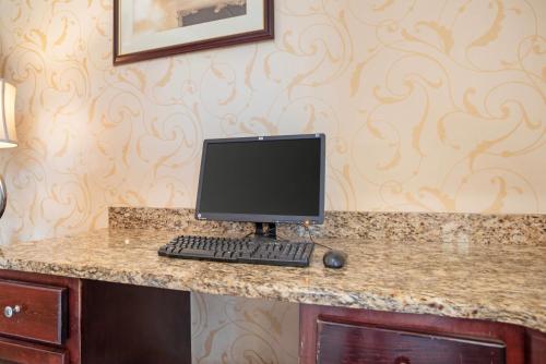 a computer monitor sitting on top of a counter at Quality Inn & Suites near Lake Eufaula in Eufaula