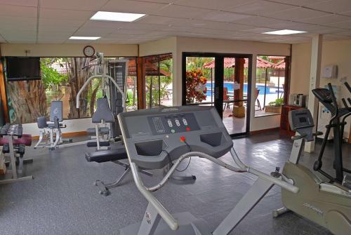a gym with treadmills and machines in a room at Country Inn & Suites by Radisson, San Jose Aeropuerto, Costa Rica in San José