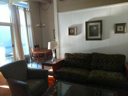 a living room with a couch and a table at Highland Gardens Hotel in Los Angeles