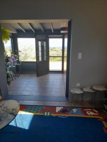 a room with a hallway with a door and chairs at Ulivi e Mare in Mesimvría