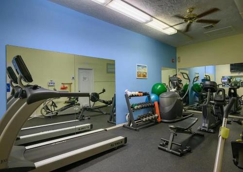 a gym with several treadmills and exercise machines at New Siesta Key Canal View in Siesta Key