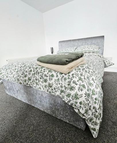 a bedroom with a bed with a gray and white comforter at 1 Bedroom Apartment in Poole in Poole