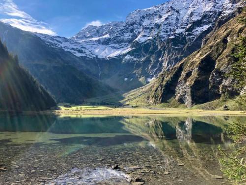 a mountain reflecting in the water of a mountain lake at Apartment in Maishofen near Ski Slopes in Maishofen