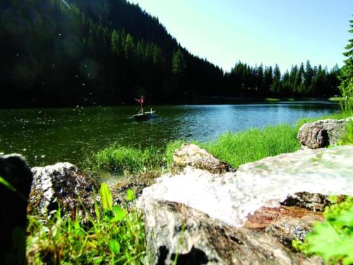 a person in a boat on a lake at Apartment in Maishofen near Ski Slopes in Maishofen