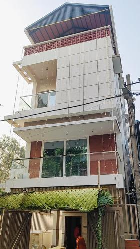 a man standing in front of a tall building at Chandra in Bengaluru