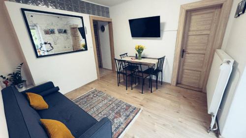 a living room with a blue couch and a table at StoneMlynska 7 Slovakia in Svit