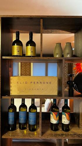a shelf with a bunch of bottles of wine at Villa Paradiso in Isola d'Asti