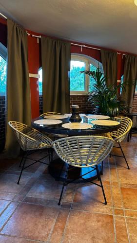 a table and chairs with plates on top of it at Villa Paradiso in Isola d'Asti