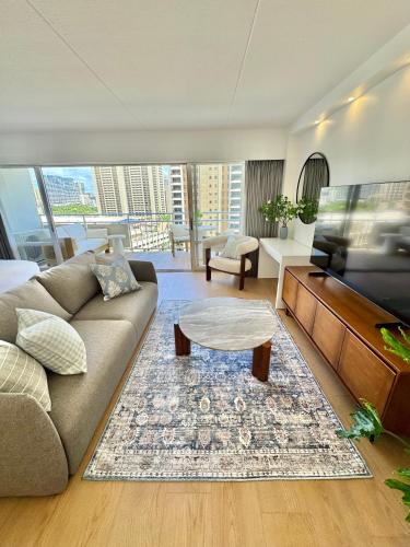 a living room with a couch and a table at Panoramic Oceanview Resort - Full Kitchen in Each Unit, 2 Swimming Pools, Onsite Restaurants, Fireworks Every Friday in Honolulu