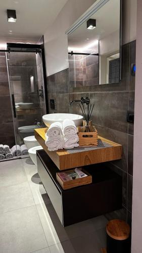 a bathroom with a tub and a sink and a mirror at Villa Paradiso in Isola d'Asti