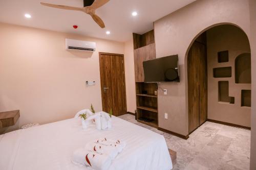 a bedroom with a bed with towels on it at S Gallery Apartment in Thôn Lại Thê