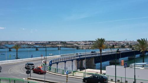 a bridge over a river with cars on the road at The Yellow House in Portimão