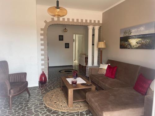 a living room with a couch and a table at Enetiko Apartments in Chios