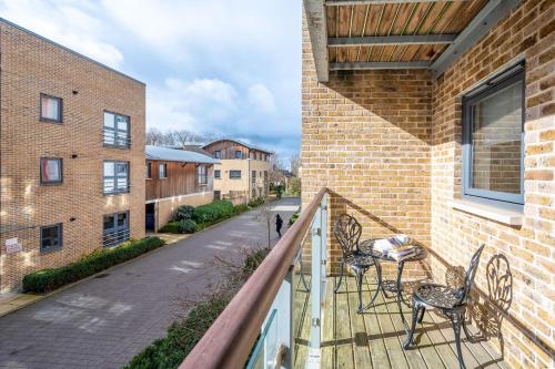 a balcony with chairs and tables on a brick building at Serviced Lettings 2 Bedrooms Central Location On site Parking in Norwich