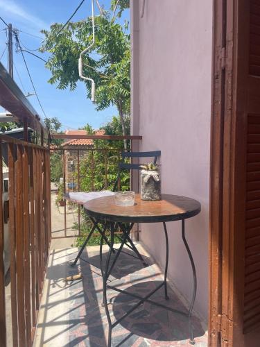 a small table on the balcony of a house at Enetiko Apartments in Chios