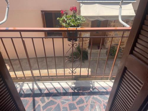 a balcony with a planter with flowers on it at Enetiko Apartments in Chios