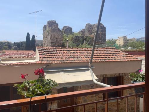 a building with a white canopy on a balcony at Enetiko Apartments in Chios