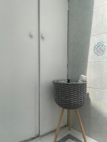a wicker basket sitting on a stand in a bathroom at Enetiko Apartments in Chios