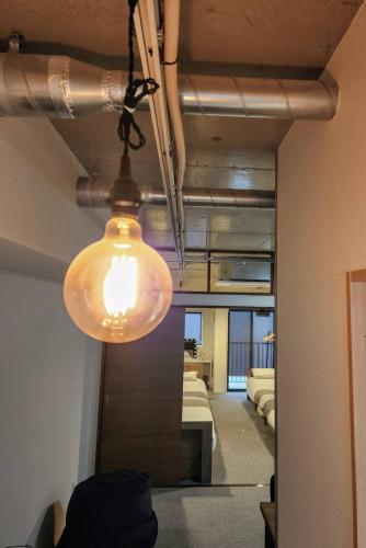 a light hanging from a ceiling in a room at LeLien Nakasu in Fukuoka