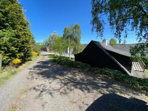 a dirt road with a house on the side at Chalet de la Troquette in Fauvillers