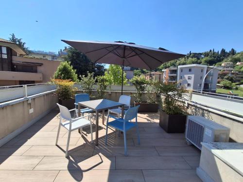 a table and chairs on a balcony with an umbrella at C'era una volta un mulino in Conegliano