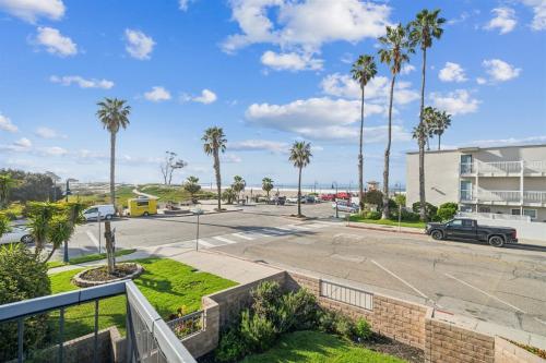 a view of a parking lot with palm trees at Beach Condo with Private Patio #133 in Carpinteria