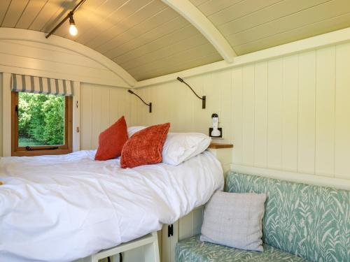 a bedroom with a bed and a chair at Hazel in Witney