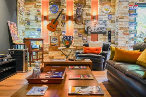 a living room with couches and a stone wall at The Classic Affair For Car Lovers in Oulad Akkou