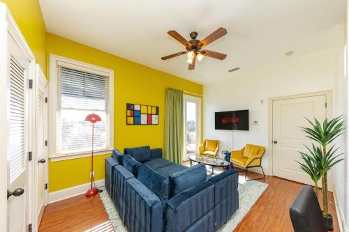 a living room with a blue couch and a ceiling fan at 30A Luxury Suite with King Bed, Parking, Pool & Balcony in Santa Rosa Beach