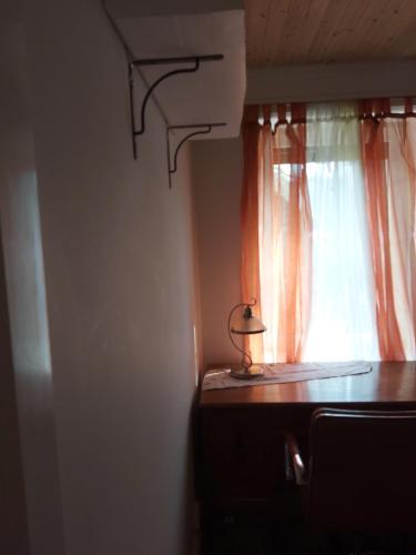 a lamp sitting on a table in front of a window at HOMESTAY ,,Aurora,, in Vilnius