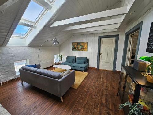 a living room with a couch and a table at Sigurd's Loft in Vossevangen
