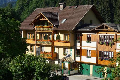 a large building with balconies and flowers on it at Pension Besser in Bad Eisenkappel