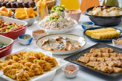 a table with many different types of food on it at Premier Hotel Cabin Shinjuku in Tokyo
