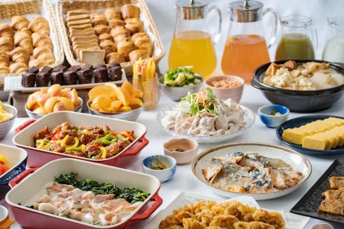 a table with many different dishes of food on it at Premier Hotel Cabin Shinjuku in Tokyo
