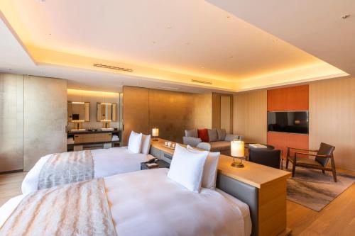 a hotel room with two beds and a living room at The Hotel Seiryu Kyoto Kiyomizu - a member of the Leading Hotels of the World- in Kyoto