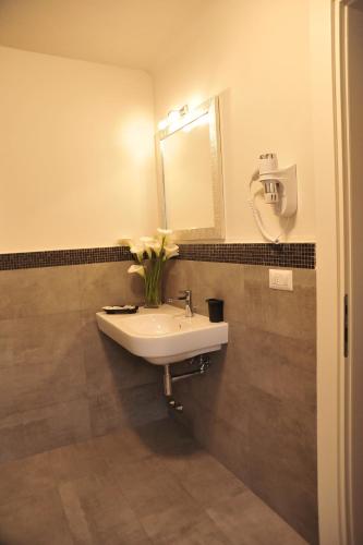 a bathroom with a white sink and a mirror at B&B Villa Anna in Lucca