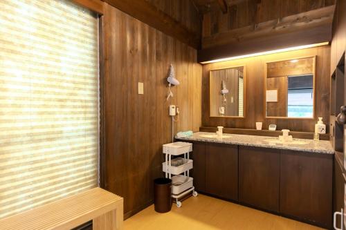 a bathroom with two sinks and a large mirror at 逸仙居 Japanese Style House in Fuefuki