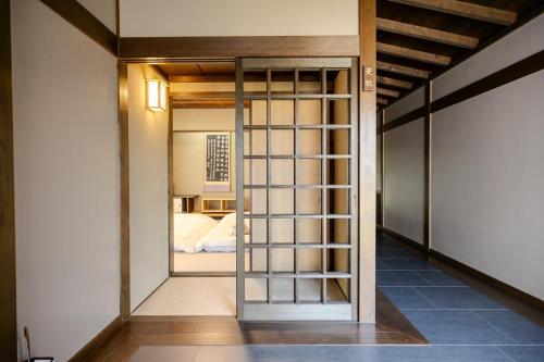 a room with a door leading to a bedroom at 逸仙居 Japanese Style House in Fuefuki