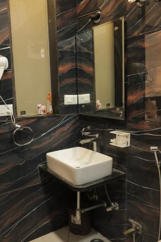 a bathroom with a sink and a mirror at Kailash Villa by Divine Stays in Udaipur